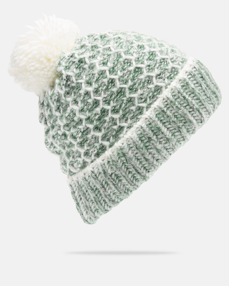 The Volcom Women’s Frosty Top Beanie is a green and white knitted winter hat featuring a textured diamond pattern and a large white faux fur pom on top, shown against a plain white background.