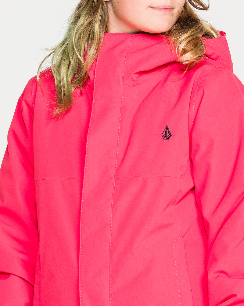 A person with light brown hair wearing the Volcom Kids’ Sass’N’Frass Insulated Jacket in bright pink, featuring a small black Volcom logo on the chest and a helmet-compatible hood, facing slightly to the side.