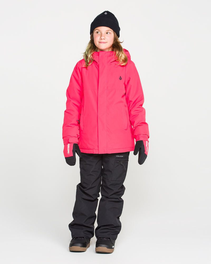 A child stands facing forward against a plain white background, wearing the Volcom Kids’ Sass’N’Frass Insulated Jacket in bright pink, made from recycled polyester, paired with black snow pants, black gloves, a black beanie, and brown winter boots.