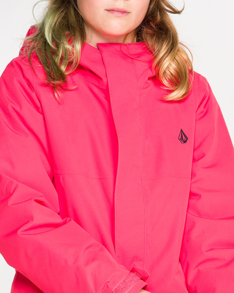 A person wearing the Volcom Kids’ Sass’N’Frass Insulated Jacket in bright pink, featuring a helmet-compatible hood, with blonde wavy hair, a partially visible face, and the Volcom logo on the chest.