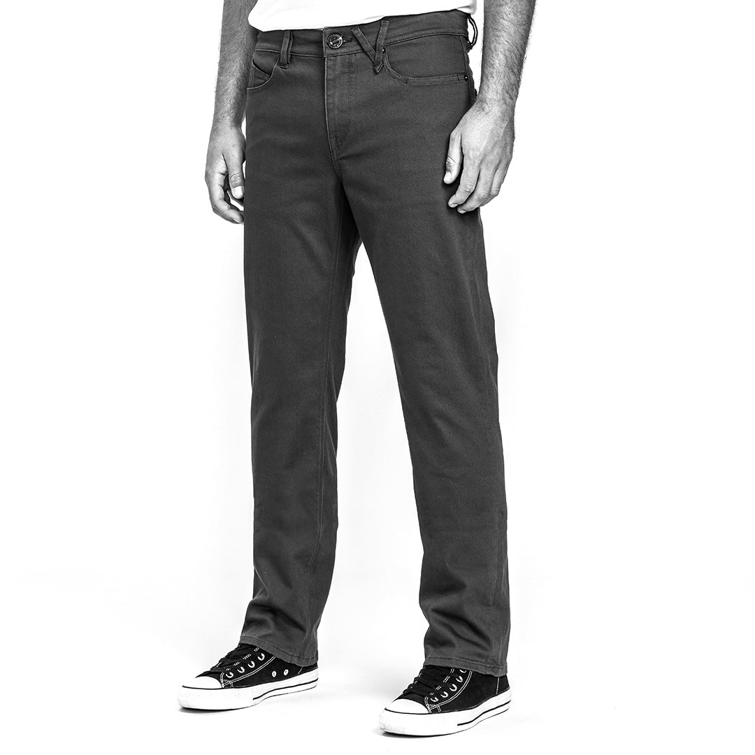 Black and white image of person wearing jeans and sneakers on a white background