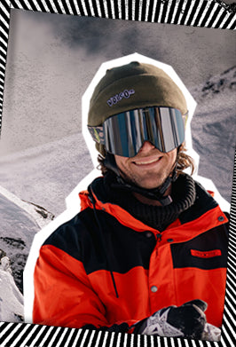 image of snowboarder wearing a green beanie hat on a snowy mountain background 
