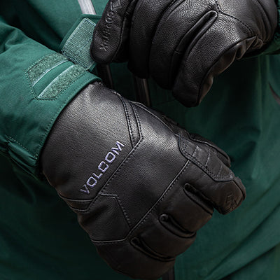 Black Volcom gloves worn with a green jacket