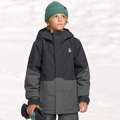 Child wearing a gray jacket with a brand logo on a white background