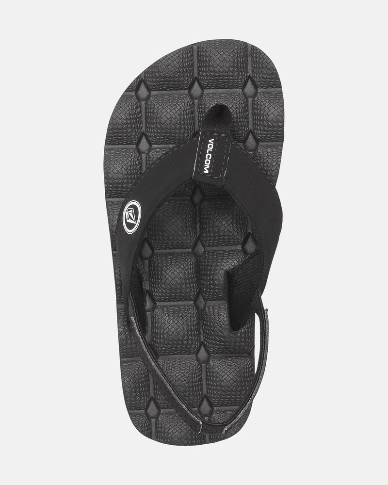The Volcom Kids' Recliner 2 Little Youth is a black youth sandal featuring a quilted comfort foam footbed and a black fabric strap with a small Volcom logo tag near the toe post.
