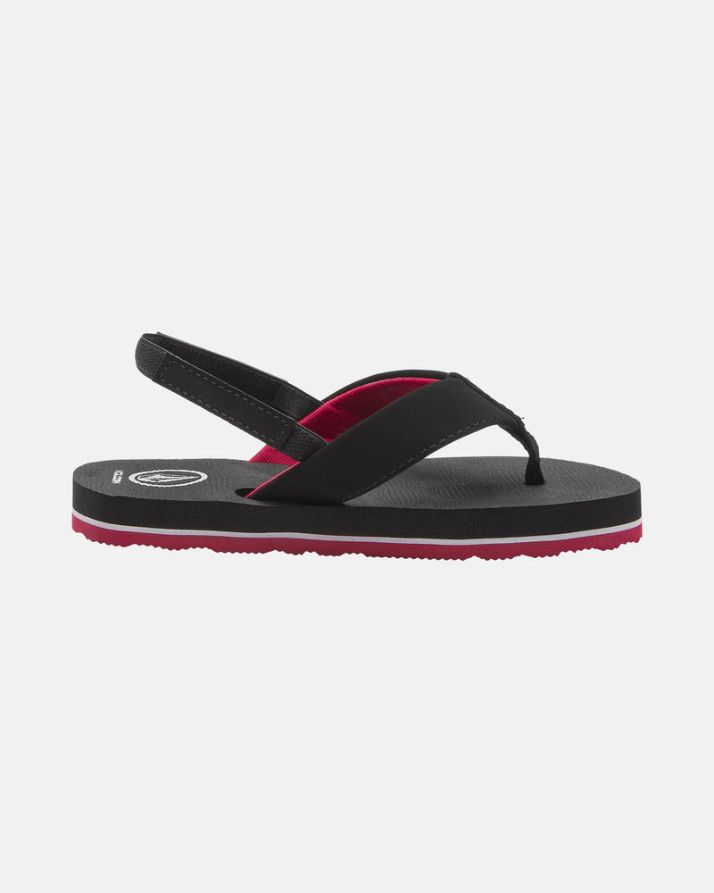 The Volcom Kids' Victor 2 Little Youth sandal features black and red colors, a thong-style toe strap, black slingback, recliner comfort foam footbed, water-friendly sole with red bottom layer, and a white circular logo near the heel.