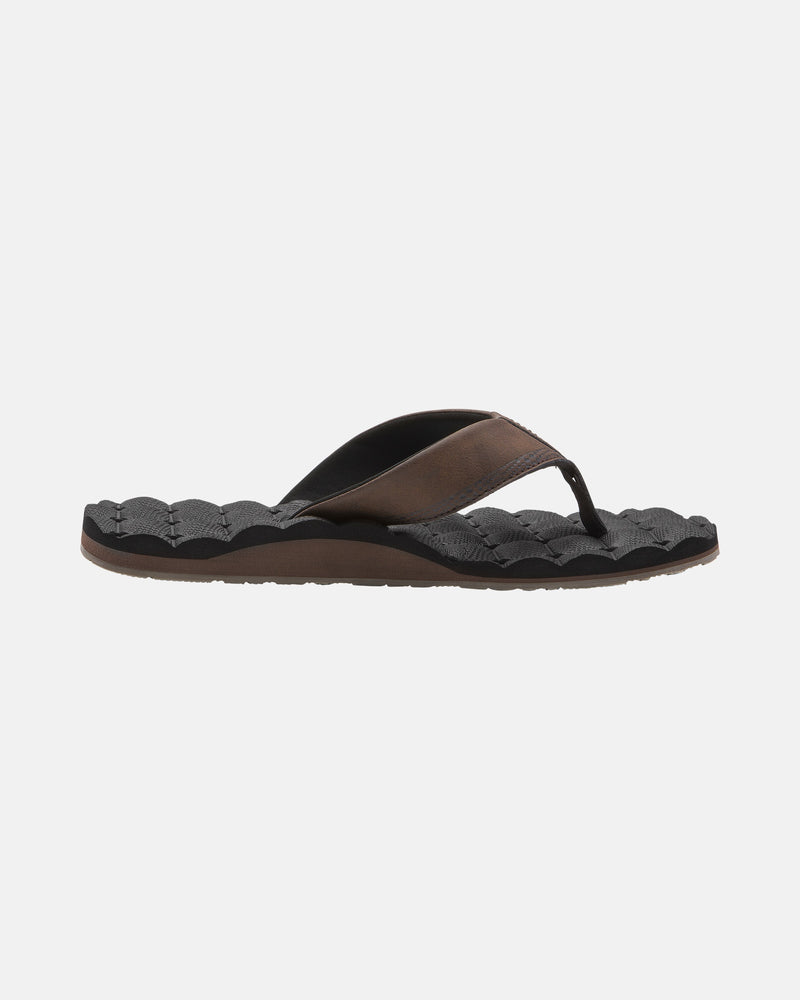 A single Volcom Men's Recliner flip-flop with a black textured sole and dark brown/black strap, shown side profile on a white background, offers extra cushy comfort.