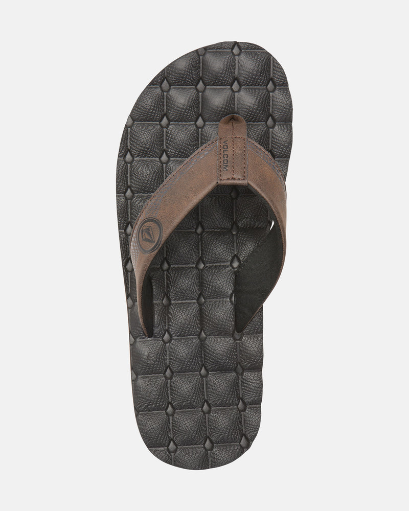A single brown Volcom Men's Recliner sandal with thick straps and an extra grippy, textured black sole, shown from above on a plain white background.