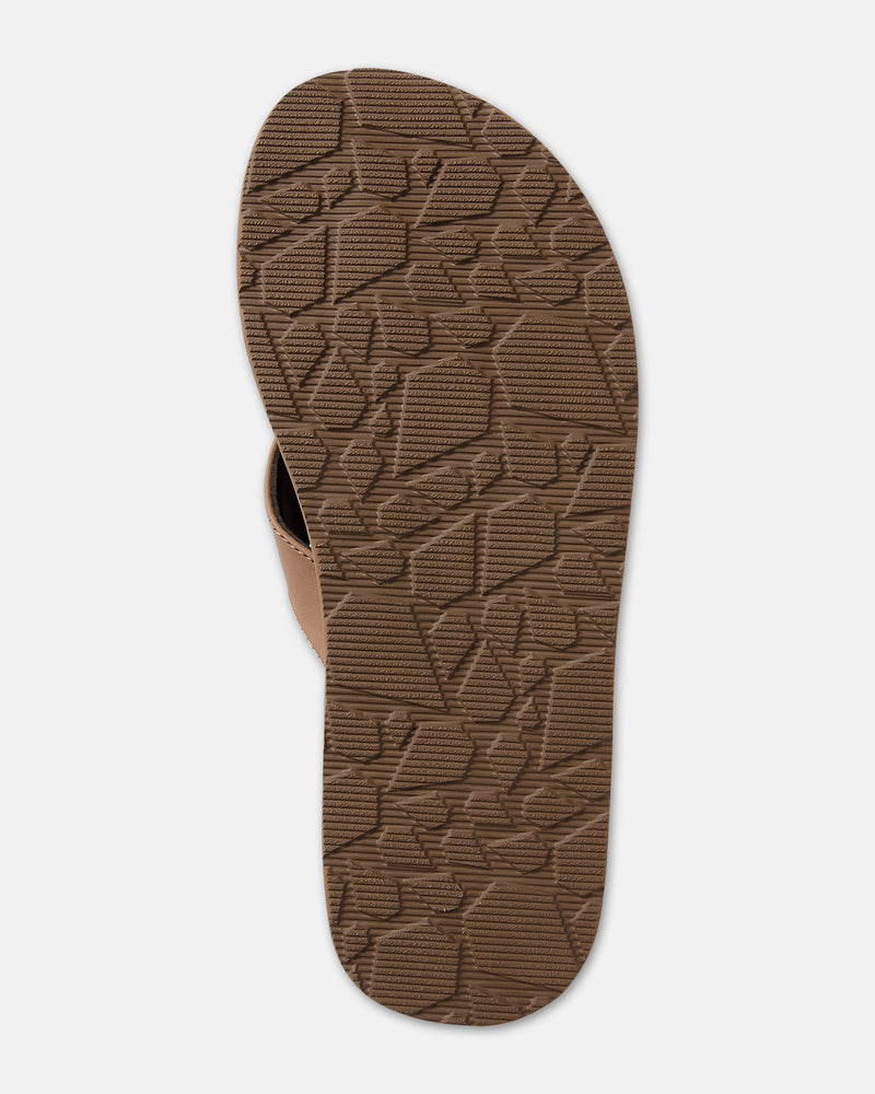 Bottom view of the Men's Victor sandal by Volcom, featuring a brown textured rubber sole with an irregular geometric pattern, photographed on a white background.