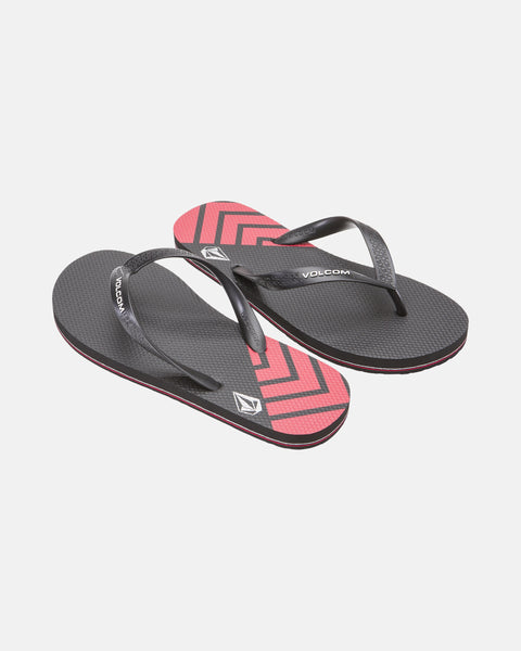 A pair of Volcom Volcomotion Mens black flip-flops with textured soles and diagonal red and black chevron patterns near the toes, displayed on a white background.