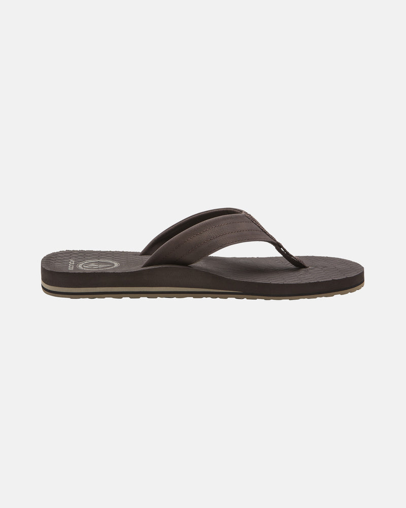 The Men's Vol-Commuter Sandals by Volcom feature a brown design with a wide strap and textured sole, displayed in a side profile on a white background.