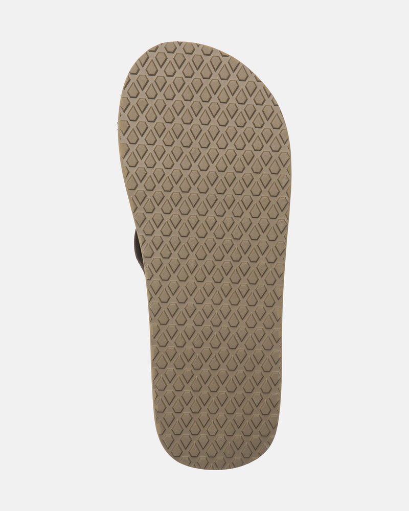 The sole of the Men's Vol-Commuter Sandals by Volcom is beige with a diamond-patterned tread, shown from the bottom against a white background.