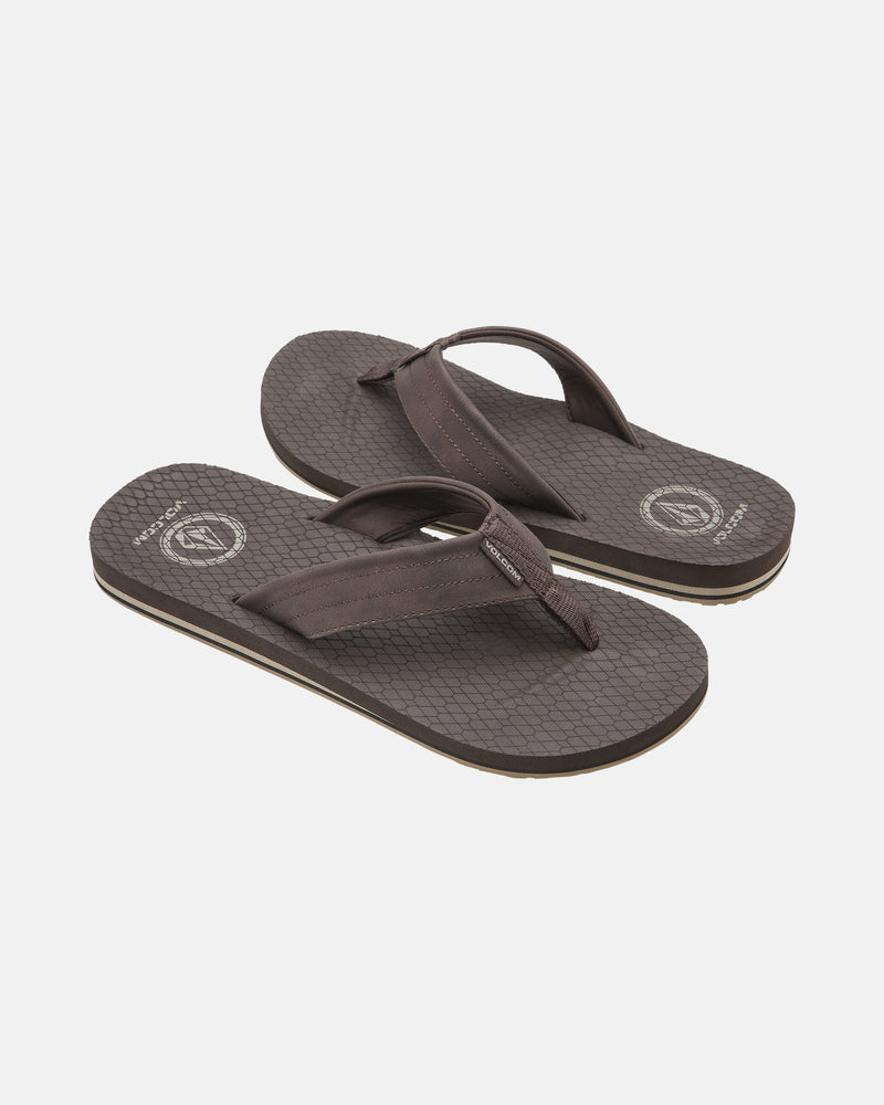 The Men's Vol-Commuter Sandals by Volcom feature brown flip-flop design with wide straps and textured soles, shown on a white background.