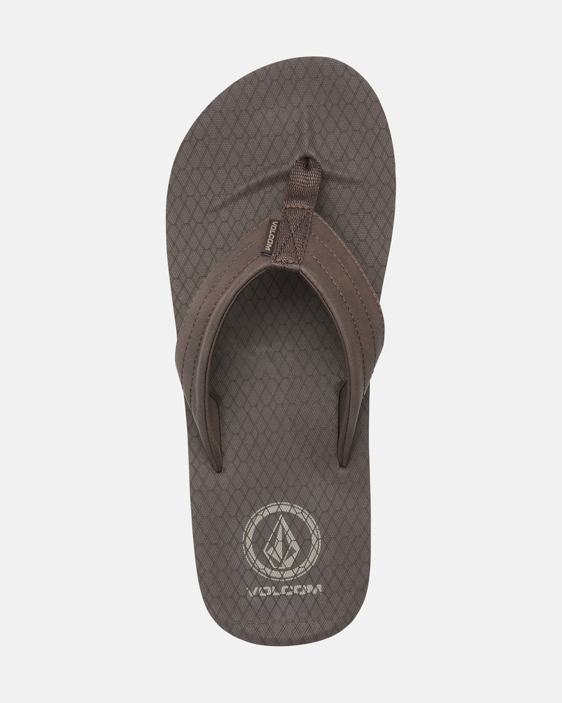 A single Men's Vol-Commuter Sandal by Volcom, featuring a brown textured sole, wide fabric straps, and the Volcom logo on the footbed, shown from above on a white background.