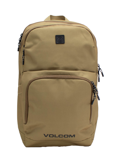Men's Roamer 3 Backpack by Volcom in tan, featuring multiple zippered compartments, black zippers, and a small black logo patch on the upper front. This spacious 22L backpack includes a padded laptop sleeve for added convenience, with the word VOLCOM printed in black at the bottom front.