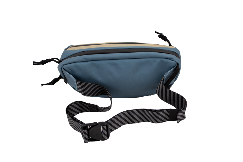 The Volcom Men's Mini Dos Pack Waist Bag features a blue design with a black-and-gray striped adjustable strap and buckle, showcased on a plain white background.