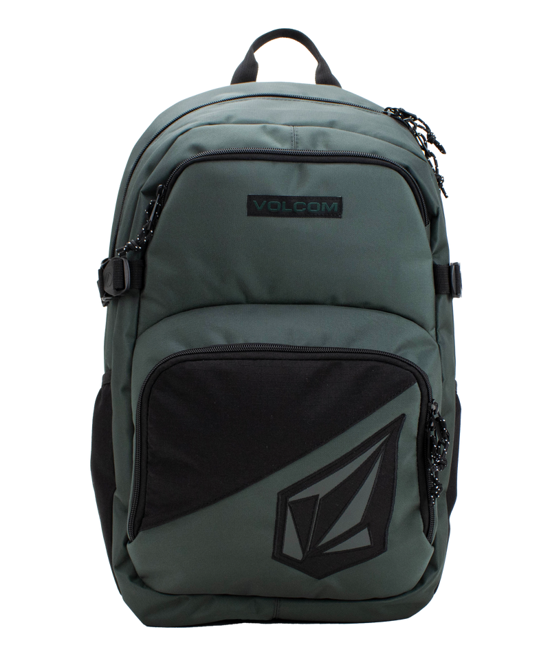 The Volcom Men’s Exponent Backpack in green features black zippers, a front pocket with the Volcom logo, and a top handle. This spacious backpack provides organized storage with two main zippered compartments and convenient side straps.