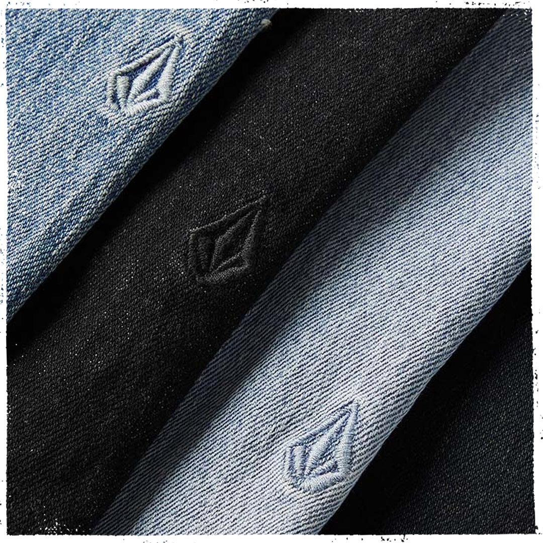 Three diagonal fabric swatches of Volcom denim in light blue, black, and a darker charcoal gray, each featuring the embossed Volcom diamond logo.
