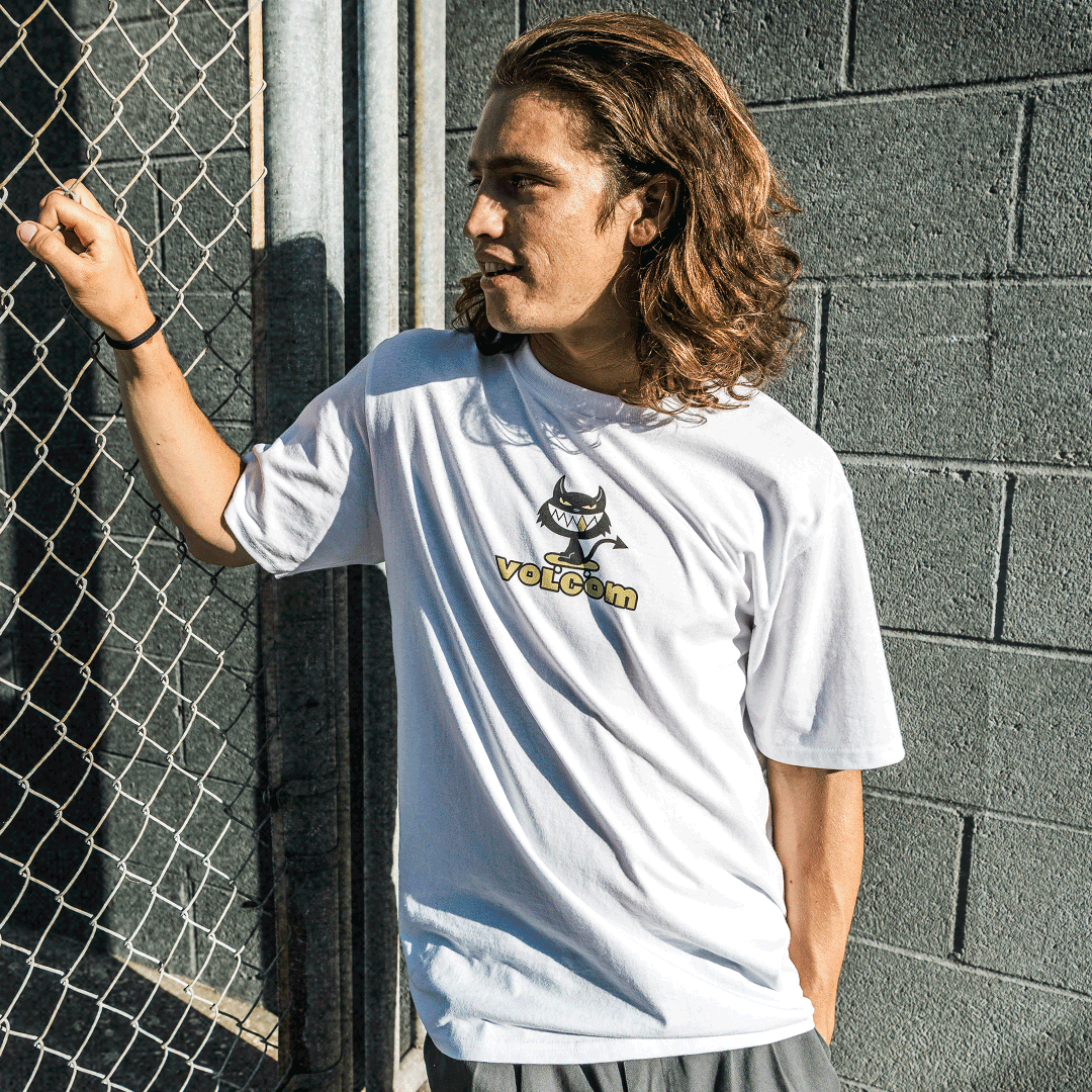 GIF of two people wearing graphic white t-shirts outside with an imp character above a cartoony Volcom logo and a Volcom logo with graphic stars replacing the "o" letters