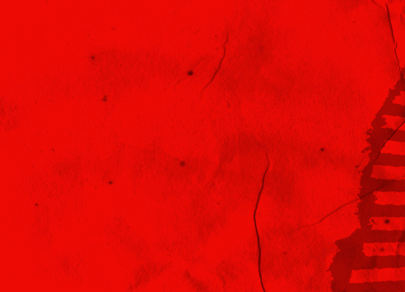 Close-up of a red textured surface with a small object on the right.