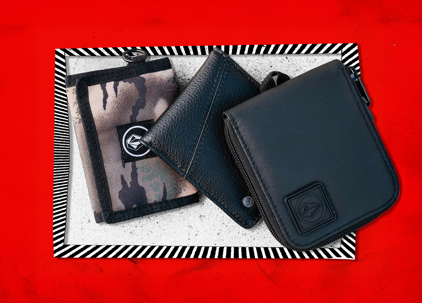 Black leather wallet on a textured surface with a red background