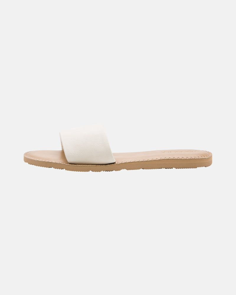 The Volcom Women's Simple Slide is a minimalist flat sandal with a tan sole and a wide white strap, shown in side profile on a plain white background.