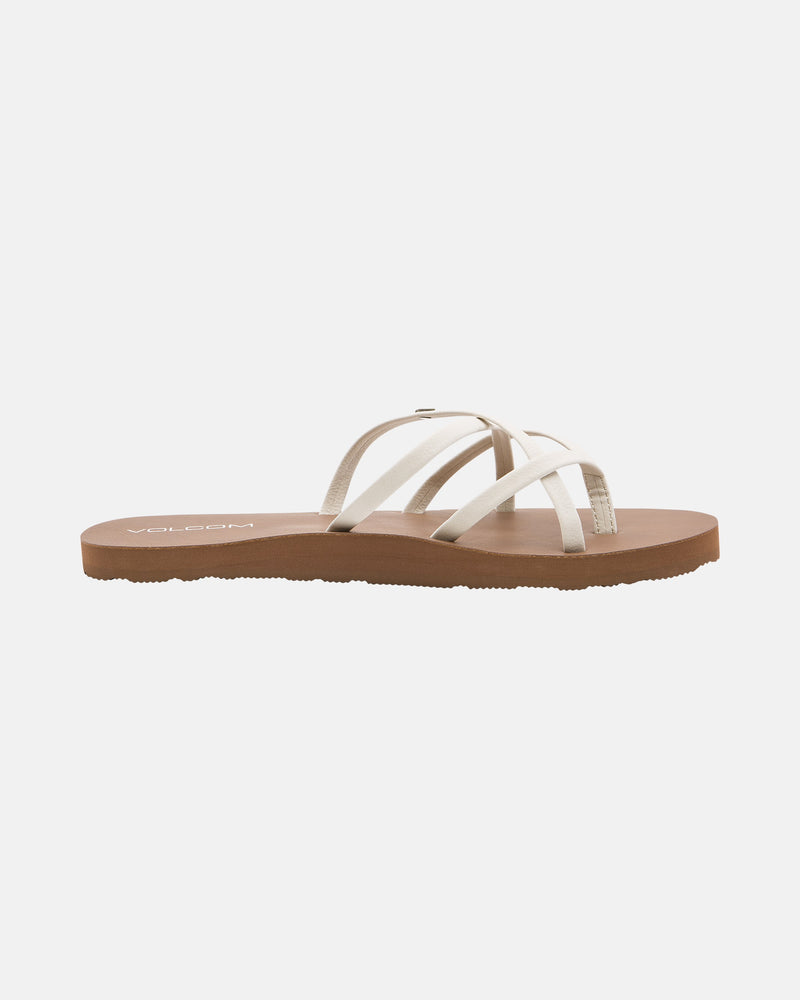 The Volcom Women's New School II sandal features thin, crisscrossed synthetic leather straps and a flat brown sole with Recliner Comfort Foam, displayed on a plain white background.