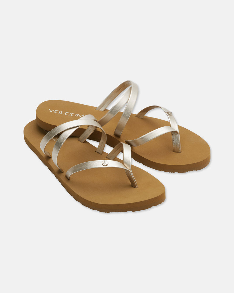 The Volcom Easy Breezy II women's sandals feature metallic silver crisscross straps, tan soles, and an EVA footbed, shown against a white background.