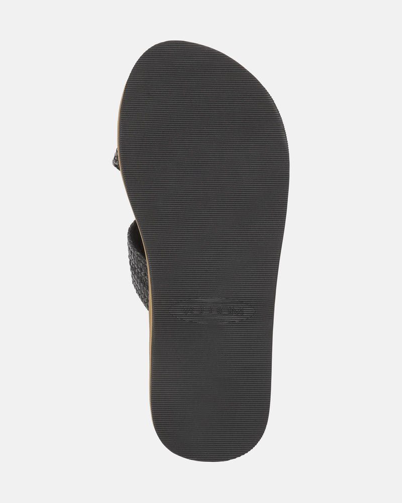The bottom view of the Women's Volcom Double Cross Sandals by Volcom shows a black sandal with a textured rubber sole featuring fine horizontal grooves for traction.