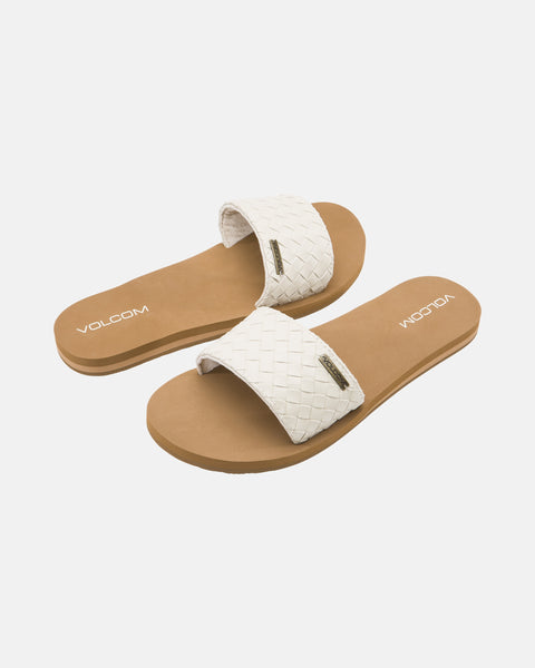 Volcom Women's Simple Slides Braid Sandals featuring tan soles and white braided straps are shown on a white background, with the Volcom logo visible on both the soles and straps.