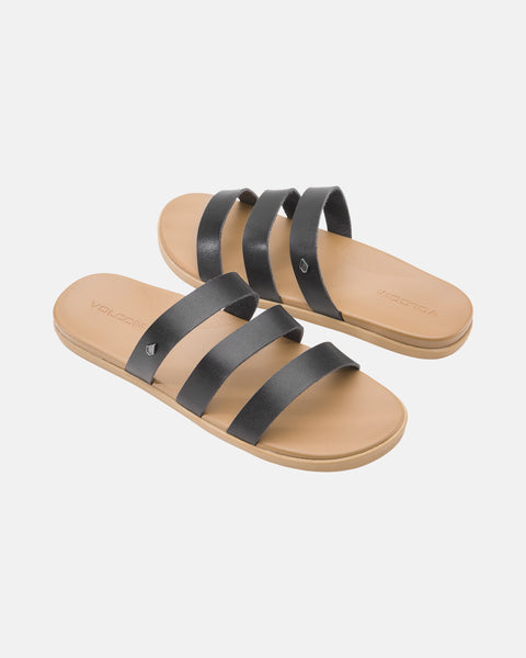 The Volcom Women's Sunseeker Sandals feature a tan slide design with three black straps across the top, shown on a plain white background.