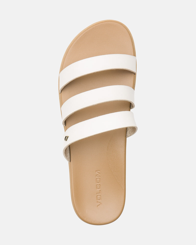 The Volcom Women's Sunseeker Sandals feature a tan base with three white horizontal straps and "VOLCOM" embossed on the footbed, shown from above against a light background.
