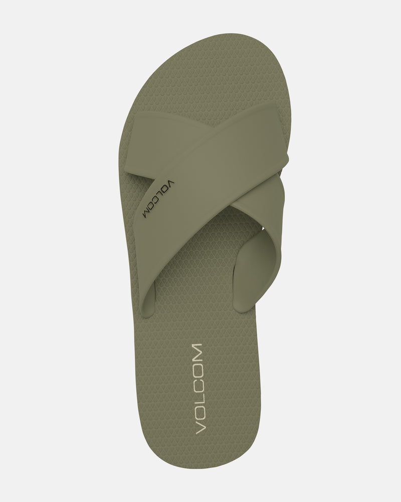 The Women's Volcomotion Strap Sandals by Volcom in olive green feature a textured footbed and two wide crisscross straps, displayed from a top-down view on a plain white background.