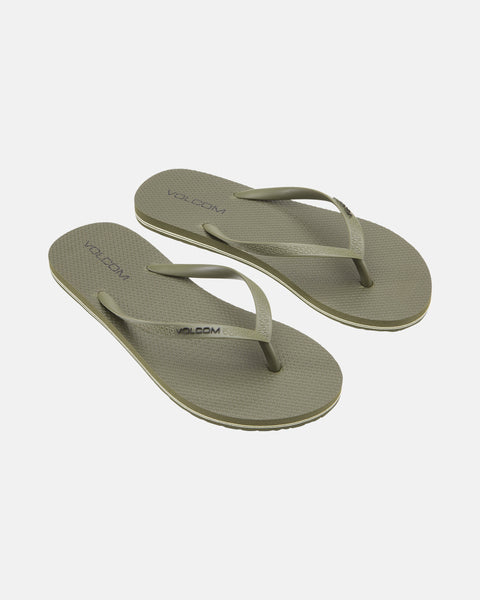 Pair of olive green Volcomotion Womens flip-flops by Volcom, featuring textured soles and simple straps, displayed on a white background.