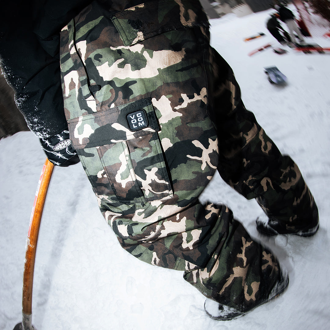 Close-up of person wearing camo-pattern Volcom-brand snow pants outdoors in the snow