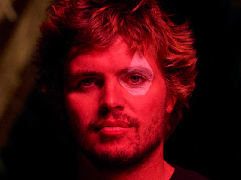 Person with red lighting on a dark background