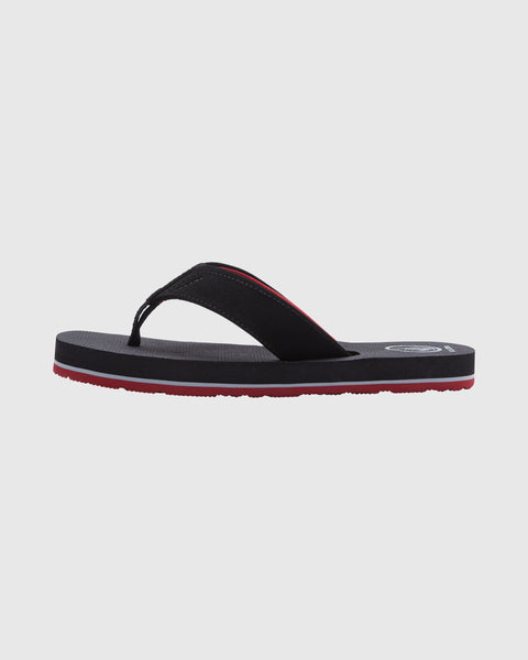 The Volcom Kids' Victor Big Youth sandal is a black flip-flop with a red stripe along the sole, shown in side profile on a plain white background. It features a water-friendly footbed for all-day comfort.