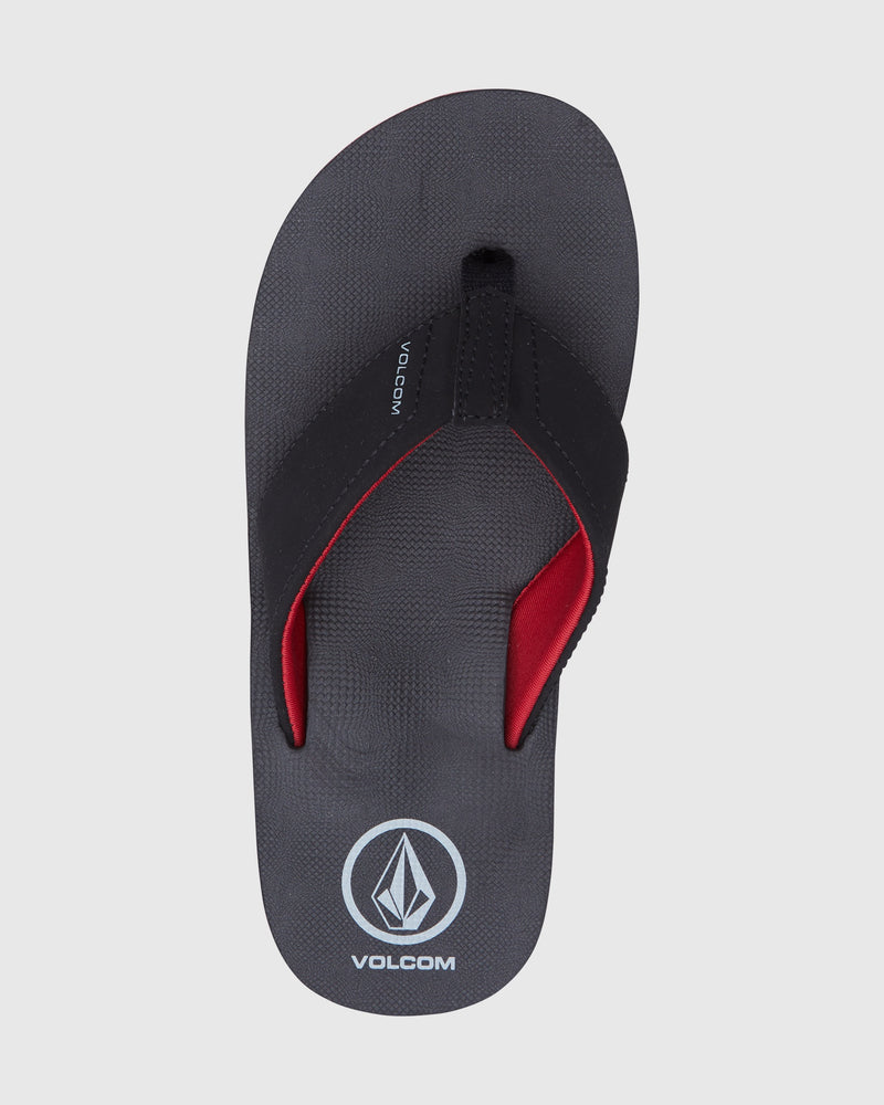 A black Volcom Kids' Victor Big Youth sandal with red padded lycra-lined straps and the Volcom logo on a water-friendly footbed, shown from above on a white background.