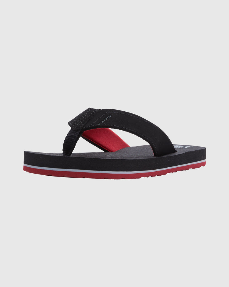 The Volcom Kids' Victor Big Youth sandal showcases a single black flip-flop design with red footbed accent and red sole on a light gray background. It offers all-day comfort with its padded lycra lining.