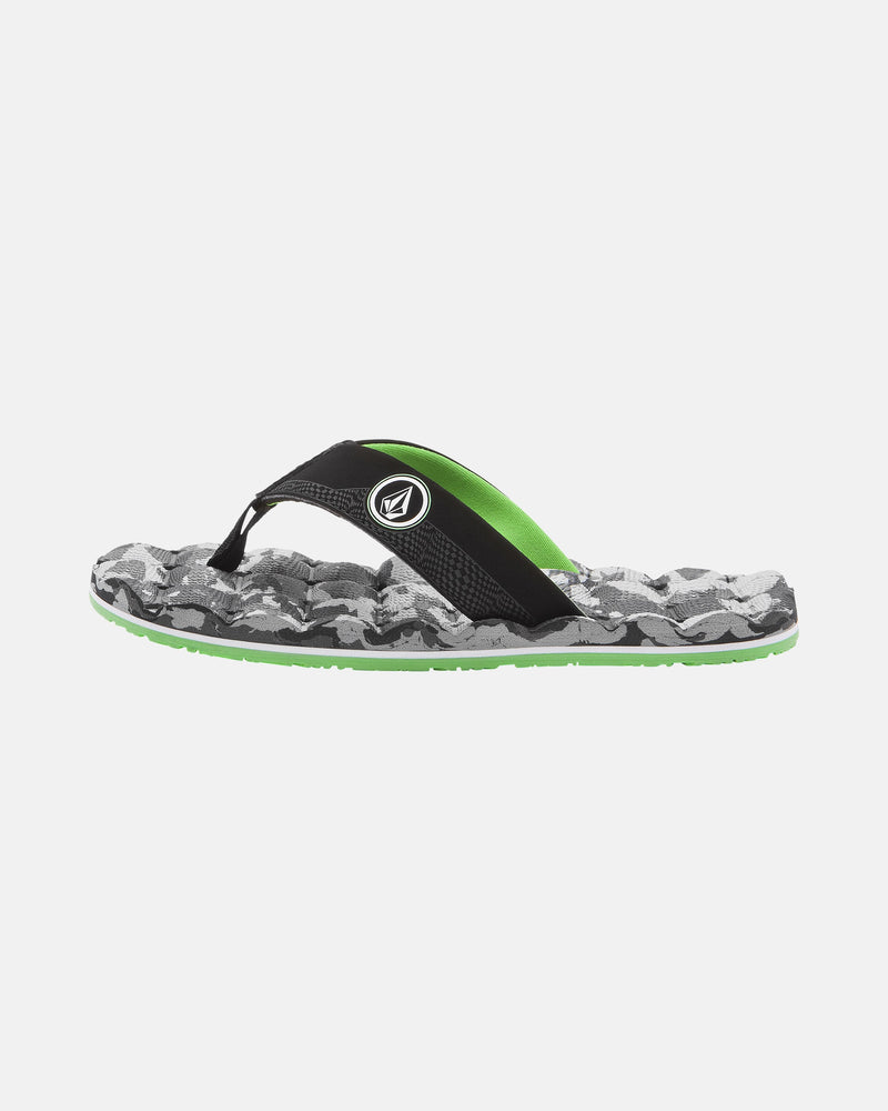 The Volcom Kids' Recliner 2 Big Youth sandal features a black and green camo-patterned, water-friendly design with a comfort foam footbed and logo on the strap, shown on a white background.