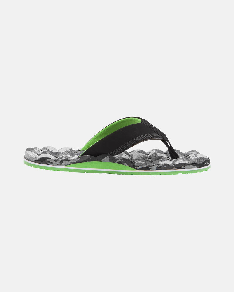 The Volcom Kids' Recliner 2 Big Youth sandal, in black and green, features a textured camo-pattern sole and a comfort foam footbed, displayed from the side on a plain white background.