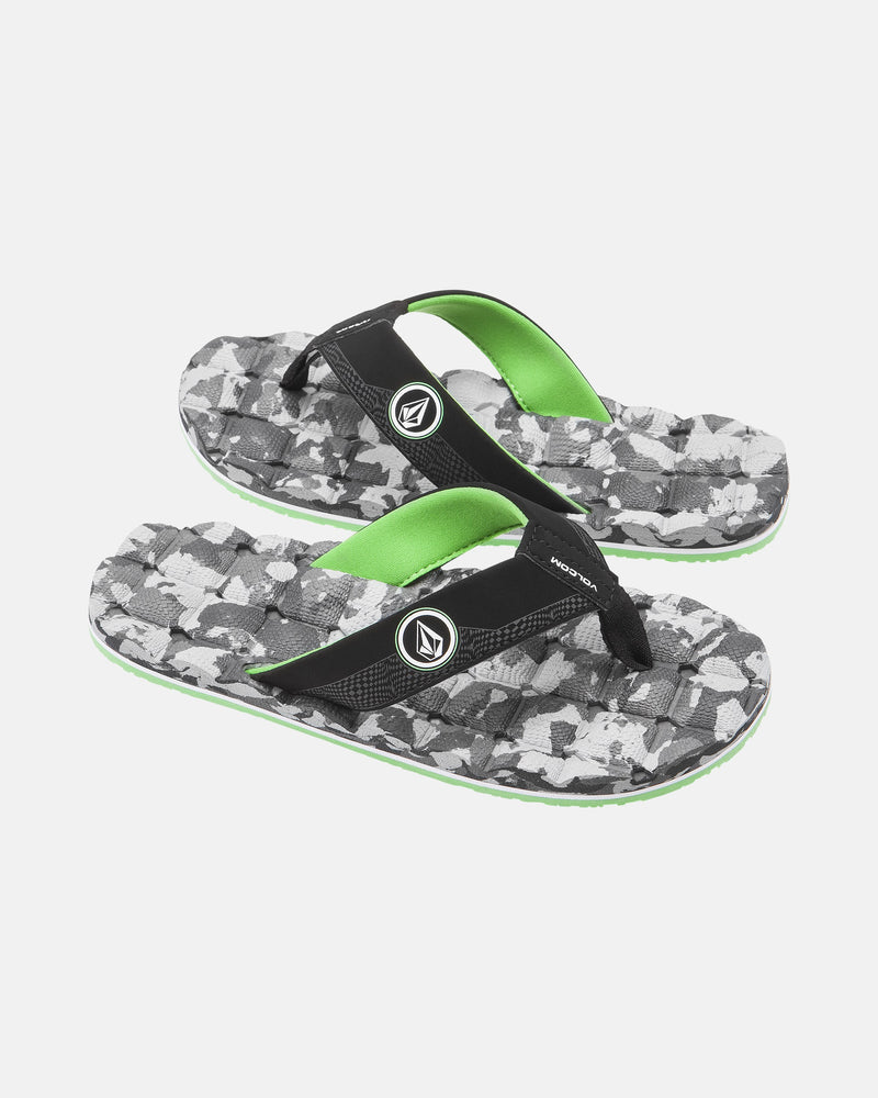 The Volcom Kids' Recliner 2 Big Youth sandals feature black and green straps with a white logo, a gray camo sole, and a comfort foam footbed for all-day wear. Shown on a plain white background.