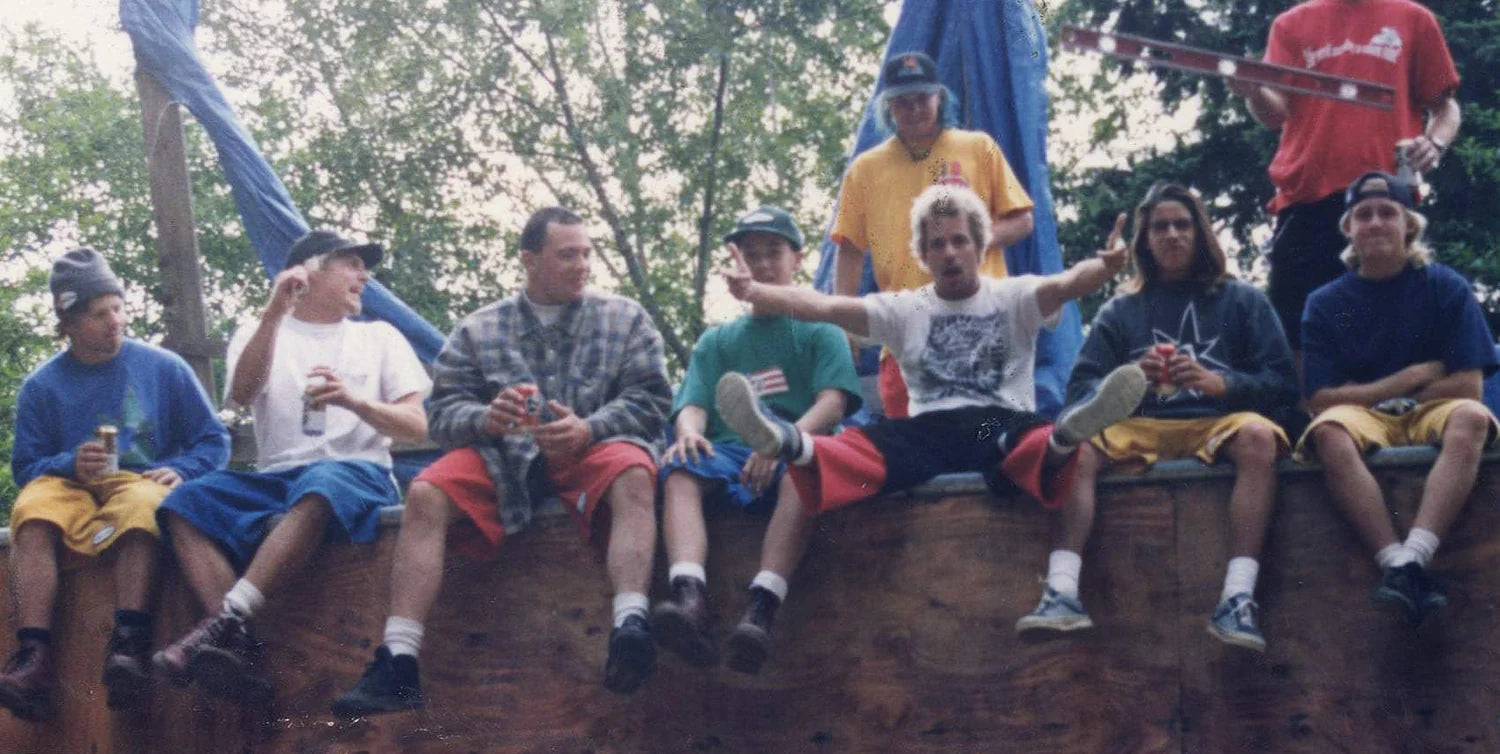 people sitting on a wooden wall wearing vintage volcom