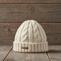 Knitted beanie with a brand tag on a wooden surface with a snowy background