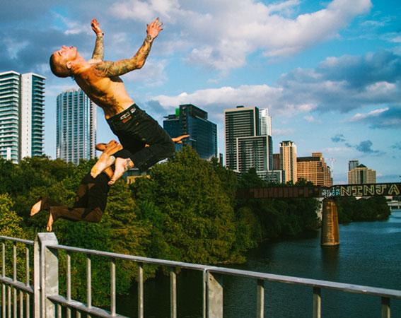 Volcom ambassadors jumping off a bridge