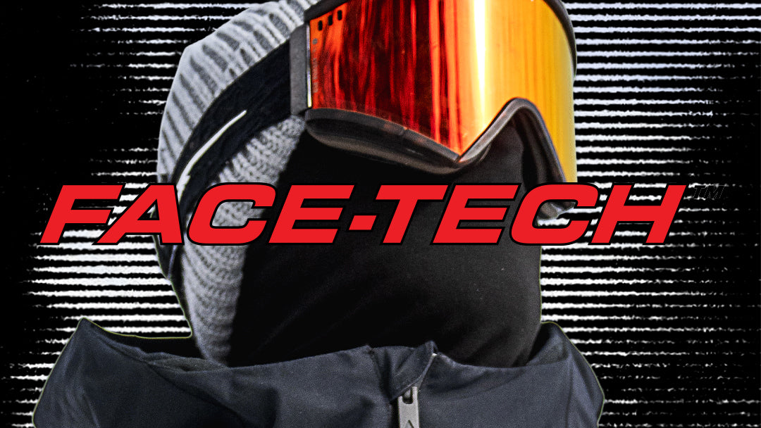 A close-up of a person wearing ski goggles with a reflective orange-red lens, a black face mask, and a gray knit beanie. Large red text reading FACE-TECH overlays the center of the image against a black background with horizontal light streaks.